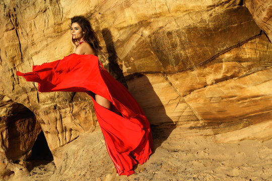 Beautiful and sensual woman wearing luxury red dress