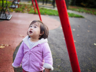 Baby girl playing at Autumn outdoor park