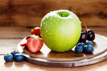 Fresh fruits on a wooden cutting board 