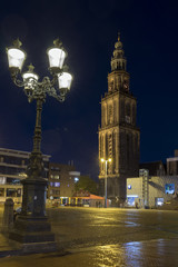 Fototapeta na wymiar martini tower illuminated at night in dutch town of groningen in the north of the netherlands on central square