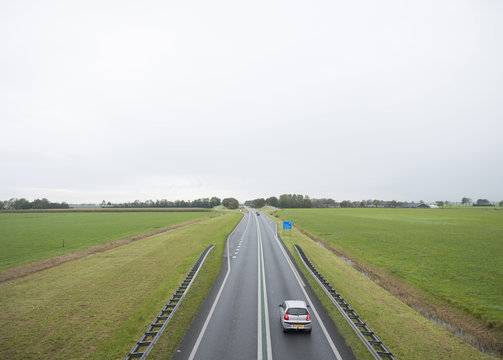 main road N46 north of groningen city between green meadows in the north of the netherlands
