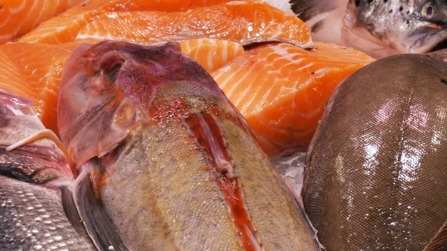 Large selection of different fresh fish on the counter of the fish market in the ice. Seafood on the Freshmarket,Red fish fillets