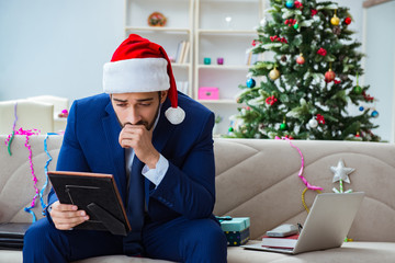 Businessman working at home during christmas