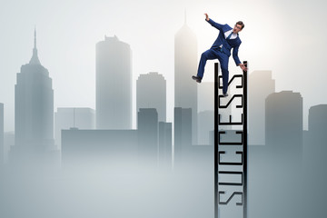 Businessman slipping from the top of ladder