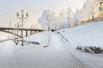 The bridge over the river is covered with ice and snow in the winter. Winter landscape.