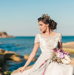 Fototapeta na wymiar Beautiful bride outdoors. Wedding hairstyle and make up outdoors