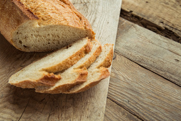 Top view of sliced wholegrain bread on a wooden table.