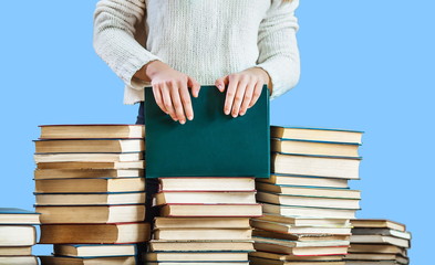 girl hands on the stack of books