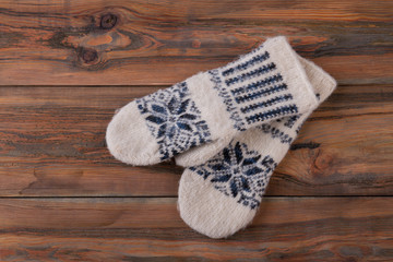 Fototapeta na wymiar Handmade mittens on wooden background