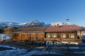 Old farmhouse in front of Kaiser Mountains in Ellmau, Austria