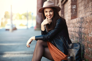 Close-up Fashion woman portrait of young pretty trendy girl posing at the city, street fashion