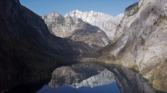 Flight over calm Obersee Lake in the Berchtesgaden National Park, Bavaria, Germany.
