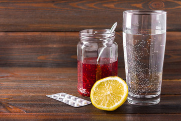 Drugs for colds - pills, spray. Folk remedies - lemon, tea, raspberry jam. Thermometer, handkerchiefs. Treatment of illness, influenza.