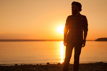 Man on shore in sunset