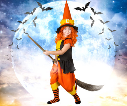 Halloween.Little girl in costume witch flying on a broom across the sky.	