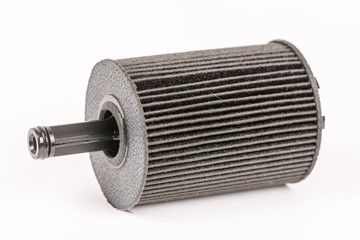 Old used and dirty car fuel filter isolated above white backgrou