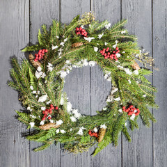 Christmas wreath of fir on a wooden background