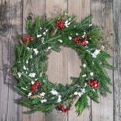 Fototapeta na wymiar Christmas wreath of fir on a wooden background