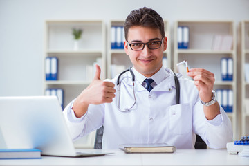 Male doctor in anti-smoking conceptwithcigarette pack