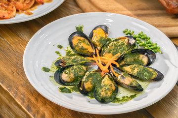 Baked mussels with carrot on plate