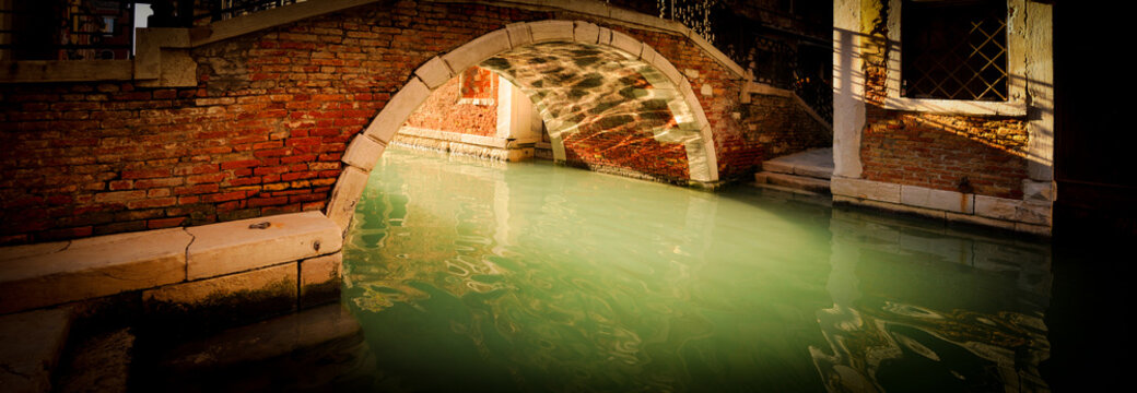 Cristal Clear Water Under A Bridge Of Venice