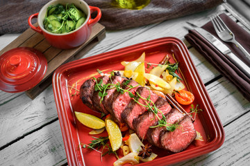 grilled Denver steak on plate with vegetables