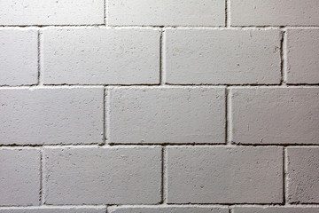 Textured surface of the gray painted brick wall 
