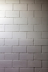 Naklejka premium Textured surface of the gray painted brick wall 