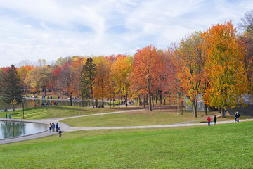 People enjoy a warm autumn day at the Beaver Lake in Mont Royal Park, Montreal
