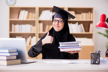 Muslim girl in hijab studying preparing for exams