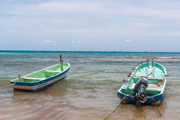 Fototapeta na wymiar Docked Boats in a Beach Scene at Playa del Carmen, Quintana Roo, Mexico