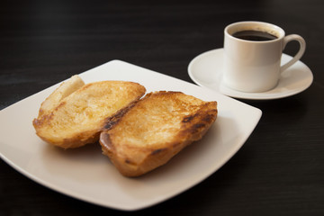 French bread toasted with butter on the plate with coffee. Pao na chapa traditional brazilian breakfast. Overview
