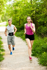 Active young couple running in the park