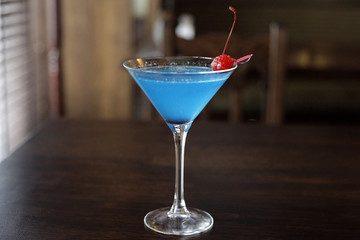 A blue lagoon cocktail in a triangle glass