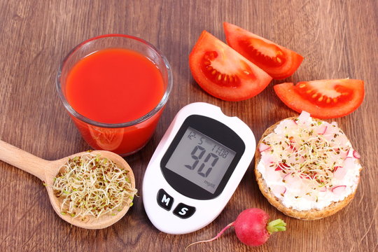 Glucometer with good result of measurement sugar level and freshly sandwich with vegetables