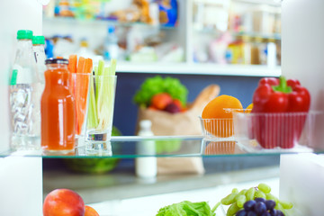 Open refrigerator with fresh fruits and vegetable. Open refrigerator