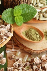 Moringa capsule for health on wood background