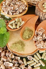 Moringa capsule for health on wood background