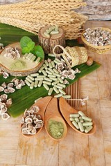 Moringa capsule for health on wood background