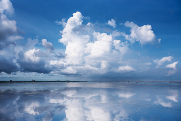 Cloud and blue sky reflect on the sea
