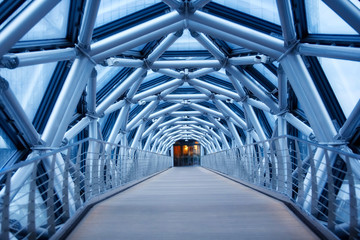 The transition between the two buildings of metal pipes