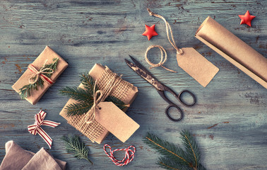 Hand crafted gifts on dark rustic wooden table with Christmas decorations