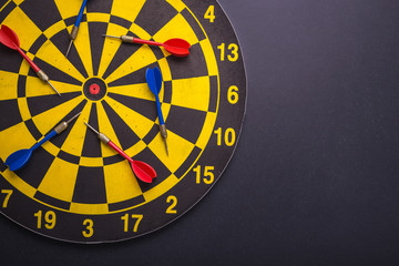 Dand dart board on black granite board background. Composition with free space for text or design