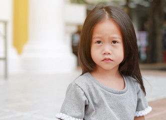 Cute asian child girl outdoor. Portrait beautiful girl looking something.