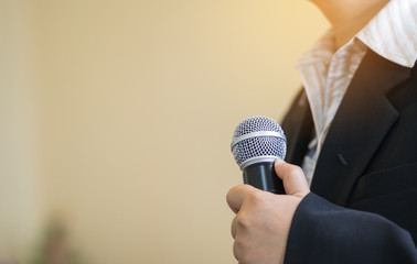 blurred of smart businesswoman speech, presentation talking with microphone, gray scale tone
