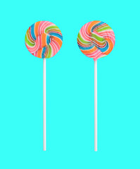 Rainbow lollipop swirl on stick isolated on sweet pastel color background.