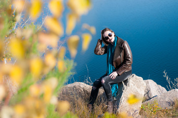 girl on a background of nature  water and yellow leaves in autumn
