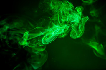 Fototapeta premium Green smoke motion on black background.