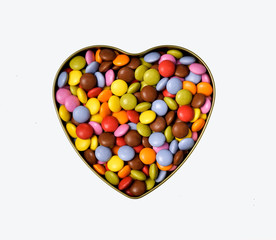 Texture of candy.Colored caramel.More scattered on the table.The heart is lined with sweets. A sweet heart.