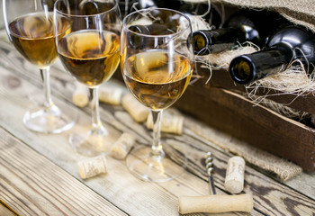 Three glasses of white wine on a wooden background. Alcoholic beverages background